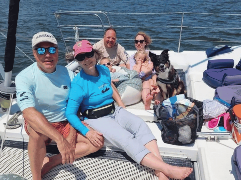 Family relaxing on the deck of the Take Two sailing catamaran
