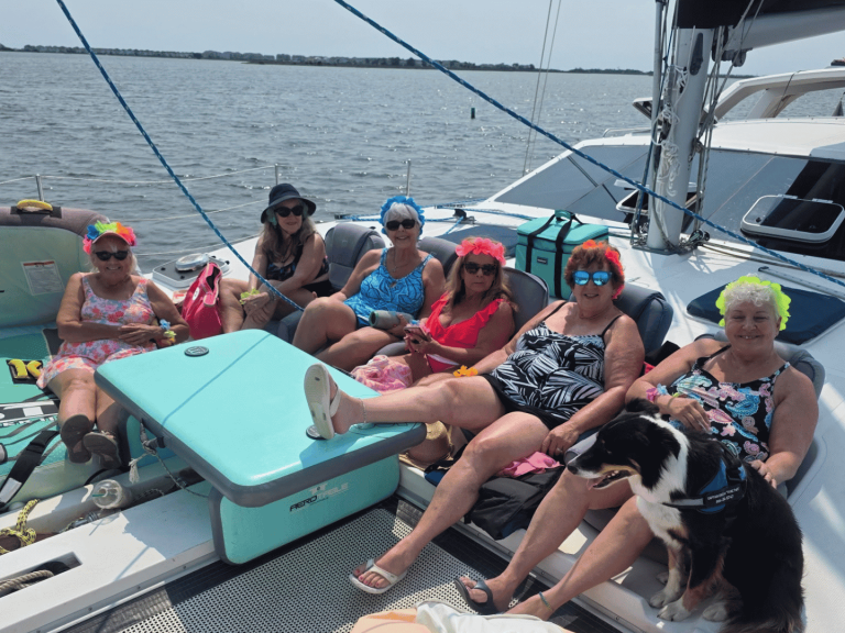 group of women with dog on private sailing catamaran cruise with causeway watersports