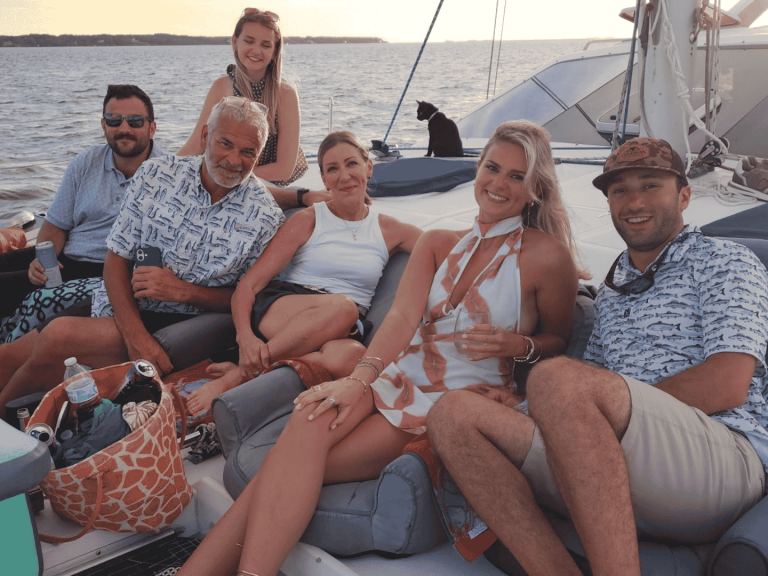group lounging on deck of catamaran on sailing cruise in outer banks in Nags Head
