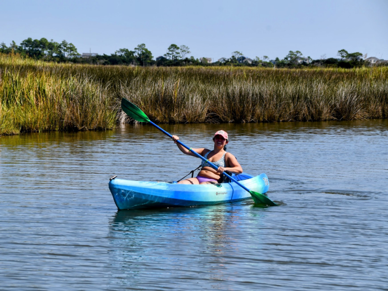 woman kayaking waterways of Nags Head with causeway watersports