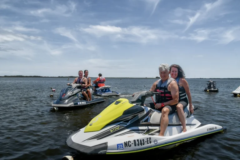 Jet ski tour group stopped together on the water in Nags Head