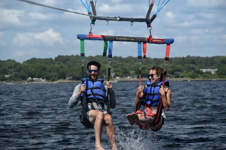 Two parasailers splashing down in Roanoke Sound near the shoreline