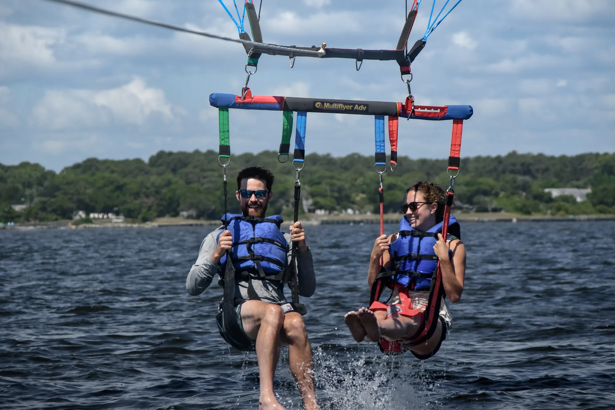 Two parasailers splashing down in Roanoke Sound near the shoreline