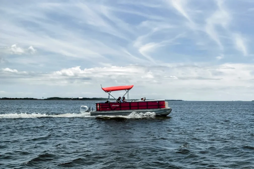 Red Bentley pontoon boat cruising Roanoke Sound