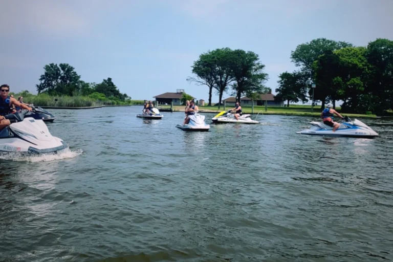 Jet ski tour group cruising a calm marsh channel in the Outer Banks