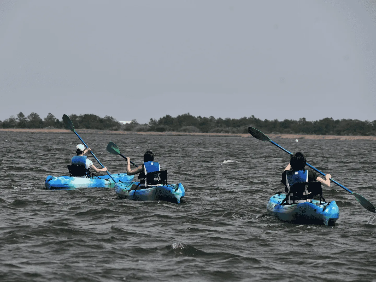 Friends paddling a kayak along a quiet Outer Banks waterway