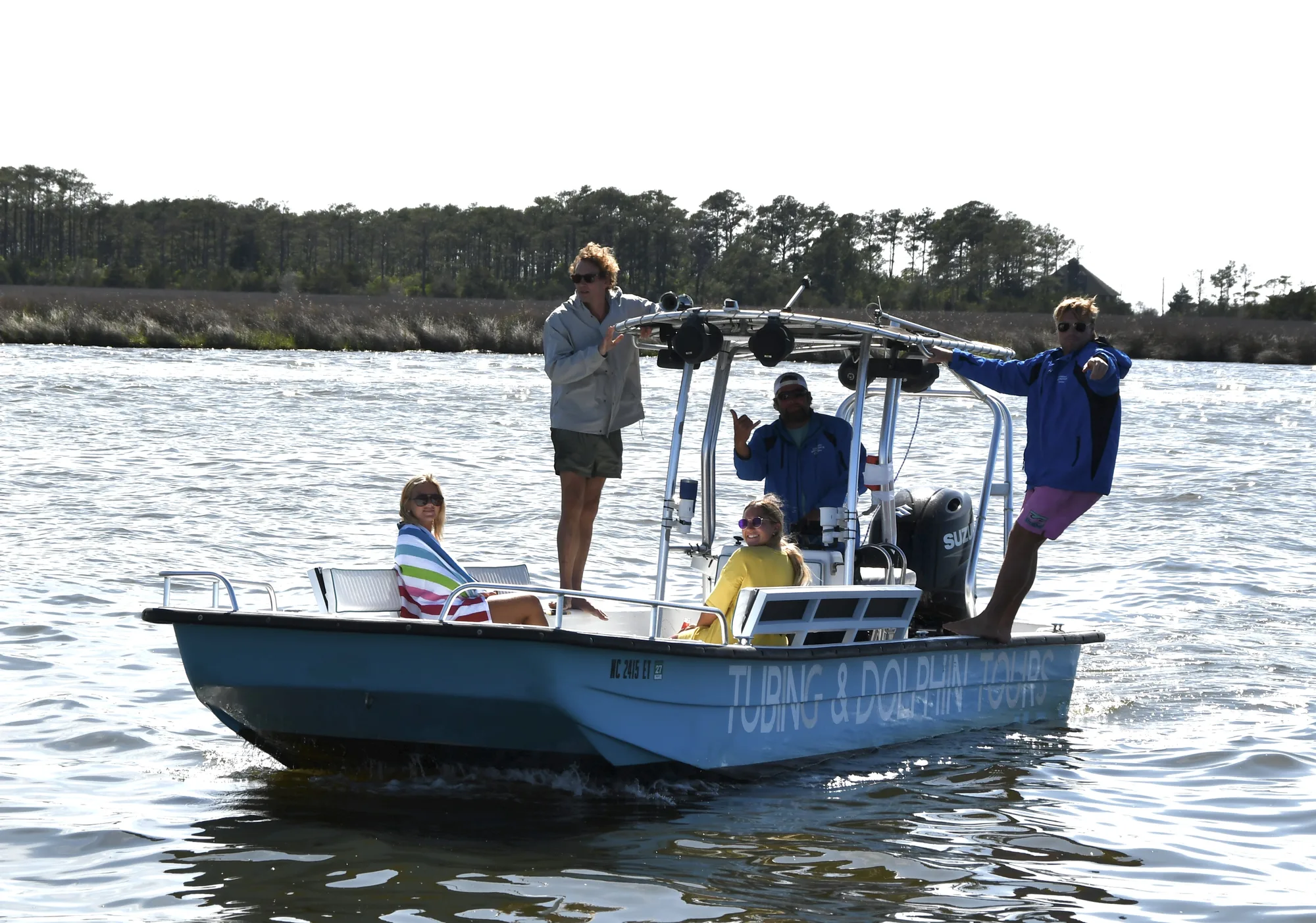 Crew and guests aboard the Tubing & Dolphin Tour boat on the sound