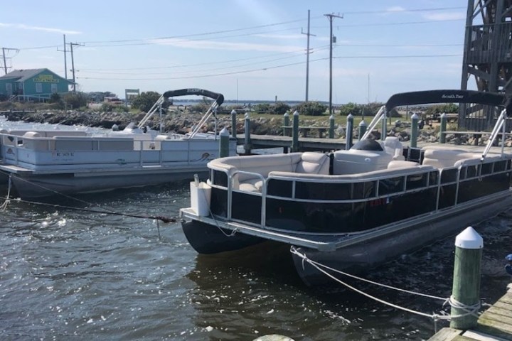 a boat is docked next to a body of water