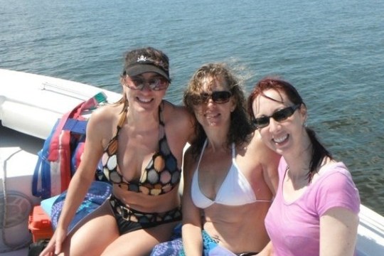 a woman sitting on a boat in the water