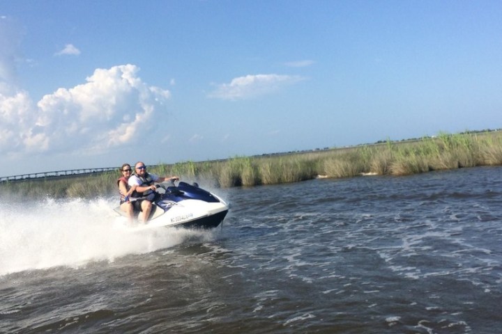 A family having a great time on a jet ski tour in the marsh lands of Nags Head NC.