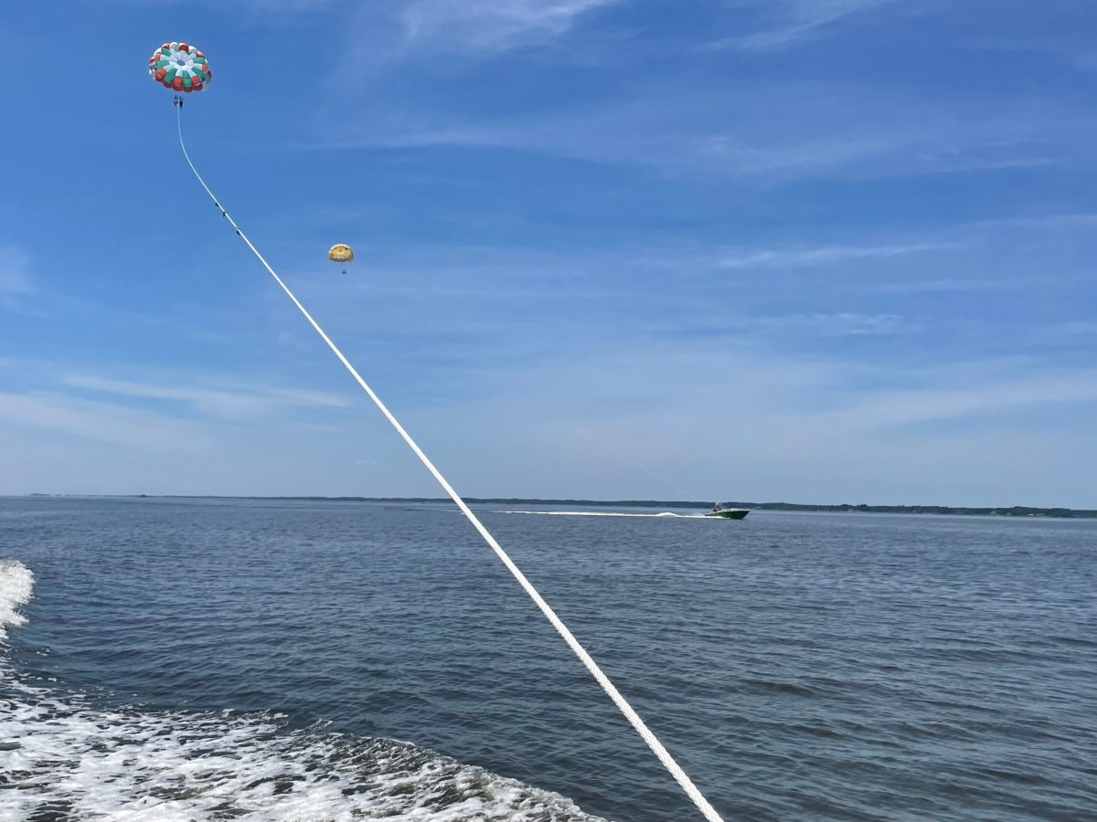 a person flying a kite in a large body of water