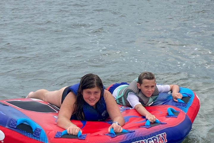 Two small children, ready for their tubing ride with Causeway Watersports.
