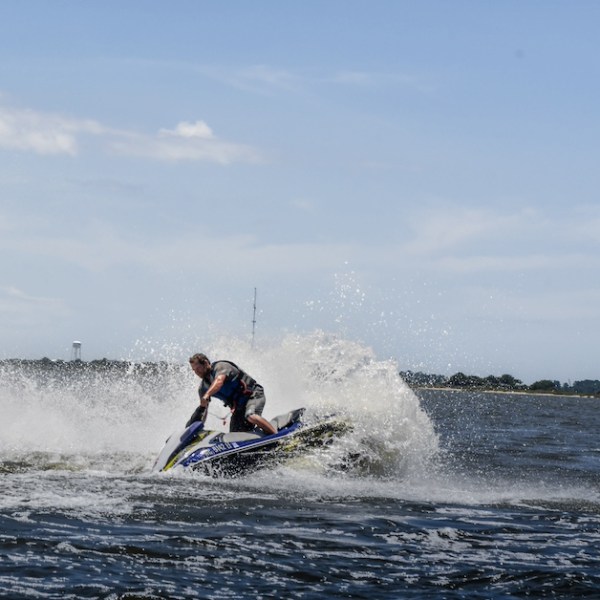 A man doing donuts on a jet ski during his rental in Nags Head NC.