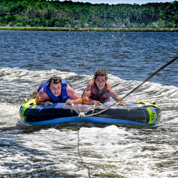 Two young men holding on tight as their tube ride begins in Nags Head.
