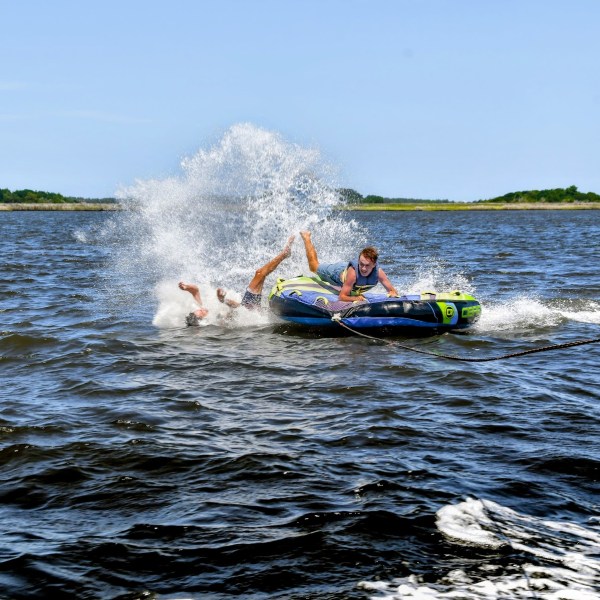 One of two people fall off the tube they are riding, during their visit to the Outer Banks.