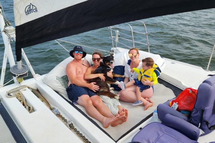 A family enjoying a day on the water aboard a sailing catamaran in Nags Head.