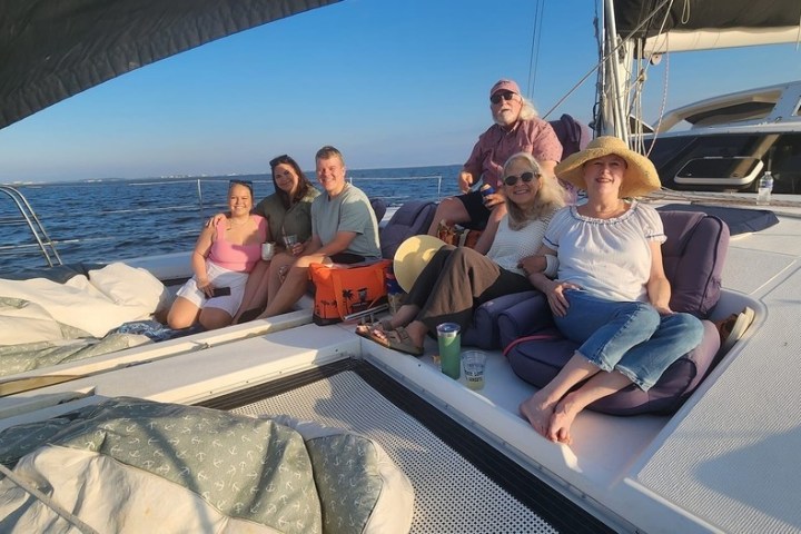 a group of people sitting at a dock
