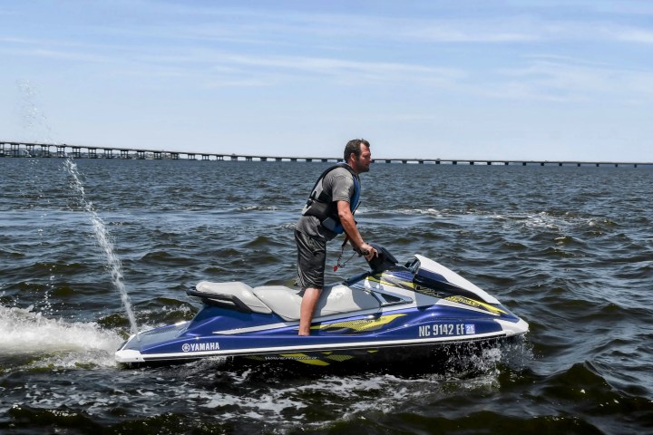 A man riding on a jet ski rental in Nags Head, while visiting the Outer Banks NC.