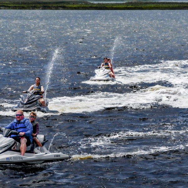A group of people returning from a jet ski tour in Nags Head.