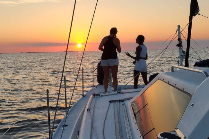 A couple enjoying a amazing OBX sunset cruise with Causeway Watersports.