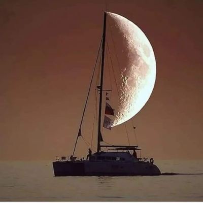A stunning shot of Take Two Sailing charter, with the moon in the bank ground, that looks like the boats sail.